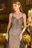 Woman in a glamorous dress standing in an elegant room with green walls and decorative elements.