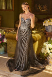 Woman in a glamorous evening gown standing in an elegant room with flowers and furniture.