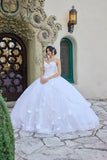 Woman in a white wedding dress standing in front of an ornate building entrance.