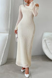 Woman wearing a long, white, sequined dress in a minimalistic room.