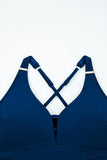 Blue bikini top with criss-cross straps on a white background